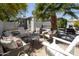 Spacious backyard featuring multiple seating areas, lounge chairs, and mature landscaping at 338 W Encanto Blvd, Phoenix, AZ 85003