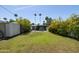 Spacious backyard with green lawn, charming patio with dining set, and mature trees at 338 W Encanto Blvd, Phoenix, AZ 85003