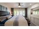 Comfortable bedroom with a ceiling fan, built-in cabinets, and a window with wooden shutters at 338 W Encanto Blvd, Phoenix, AZ 85003