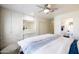 Bright bedroom with a ceiling fan, built-in cabinets, and ensuite bathroom with toilet and sink at 338 W Encanto Blvd, Phoenix, AZ 85003