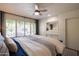 Bright bedroom featuring a ceiling fan and a window with wooden shutters for natural light at 338 W Encanto Blvd, Phoenix, AZ 85003