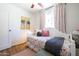 Cozy bedroom featuring a comfortable bed, ceiling fan, and bright natural light at 338 W Encanto Blvd, Phoenix, AZ 85003