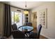 Charming dining area with backyard access and a unique round table with modern chairs at 338 W Encanto Blvd, Phoenix, AZ 85003