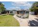 Quaint single-story home with a lush lawn, decorative landscaping, and distinctive awnings at 338 W Encanto Blvd, Phoenix, AZ 85003