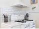Kitchen area with vintage gas range stove and subway tile backsplash at 338 W Encanto Blvd, Phoenix, AZ 85003