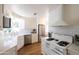 Bright kitchen featuring white cabinets, stainless steel appliances, and subway tile backsplash at 338 W Encanto Blvd, Phoenix, AZ 85003