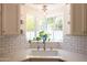 Well-lit kitchen sink with a corner window, showcasing a serene outdoor view at 338 W Encanto Blvd, Phoenix, AZ 85003