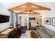 Cozy living room with vaulted beam ceiling, mini-bar, and views of the bathroom at 338 W Encanto Blvd, Phoenix, AZ 85003