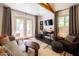 Sunlit living room features french doors, vaulted ceiling, and a dedicated work space for modern living at 338 W Encanto Blvd, Phoenix, AZ 85003