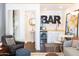 Stylish living room featuring a bar, seating area, and powder room for guest convenience at 338 W Encanto Blvd, Phoenix, AZ 85003