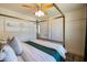 Bright main bedroom boasts a comfortable bed, ceiling fan, and ample closet space at 338 W Encanto Blvd, Phoenix, AZ 85003