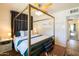 Stylish main bedroom with a four-poster bed, ceiling fan, and elegant furnishings at 338 W Encanto Blvd, Phoenix, AZ 85003