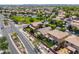 This aerial view captures a community with well-maintained homes, green spaces, and a glimpse of a refreshing pool at 3788 E Sexton St, Gilbert, AZ 85295