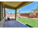 View of backyard with artificial turf, basketball hoop, covered patio, and decorative brick wall at 3788 E Sexton St, Gilbert, AZ 85295