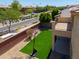 View of a well-kept backyard with artificial grass, a basketball hoop, and a view of the second-story balcony at 3788 E Sexton St, Gilbert, AZ 85295