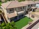 An aerial view showcases a home's backyard featuring a manicured lawn, a basketball hoop, and ample space for outdoor activities at 3788 E Sexton St, Gilbert, AZ 85295