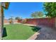 Backyard featuring artificial turf, brick wall, and a portable basketball hoop for recreational activities at 3788 E Sexton St, Gilbert, AZ 85295