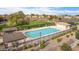 A community pool with picnic tables and lounge chairs is surrounded by greenery and other amenities at 3788 E Sexton St, Gilbert, AZ 85295