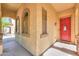 Inviting front porch with stone pillars, arched windows, and a vibrant red door at 3788 E Sexton St, Gilbert, AZ 85295