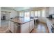 Open kitchen with island sink, stainless steel dishwasher, and sliding glass door to backyard at 3788 E Sexton St, Gilbert, AZ 85295