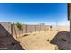 A fenced in backyard with a gravel ground covering and sparse desert foliage at 4034 W Nora Dr, San Tan Valley, AZ 85144