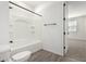 Bathroom with white toilet, white walls, and a tiled shower-tub combo at 4034 W Nora Dr, San Tan Valley, AZ 85144