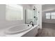 Clean bathroom featuring a soaking tub, separate glass shower, and tile flooring at 4034 W Nora Dr, San Tan Valley, AZ 85144