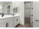 Modern bathroom with double sink vanity, white cabinets, and black hardware accents at 4034 W Nora Dr, San Tan Valley, AZ 85144
