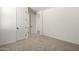 A bedroom with carpet, white walls, doors, and a view into a bathroom at 4034 W Nora Dr, San Tan Valley, AZ 85144