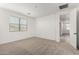 Bright bedroom with neutral carpet, white walls, and a window providing natural light at 4034 W Nora Dr, San Tan Valley, AZ 85144
