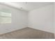 A well lit bedroom space with a window and freshly cleaned carpet at 4034 W Nora Dr, San Tan Valley, AZ 85144