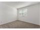Bedroom features neutral carpet and white walls with a window providing natural light at 4034 W Nora Dr, San Tan Valley, AZ 85144