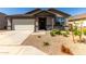 Charming single-story home featuring a well-maintained front yard with gravel landscaping and a two-car garage at 4034 W Nora Dr, San Tan Valley, AZ 85144