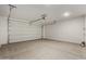 A garage with a cement floor and a large white garage door at 4034 W Nora Dr, San Tan Valley, AZ 85144