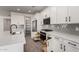 Well-equipped kitchen with pull-out drawers, stainless steel appliances, modern white cabinetry, and a large island at 4034 W Nora Dr, San Tan Valley, AZ 85144