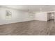 Bright and spacious living room with wood-look flooring, recessed lighting, and neutral paint at 4034 W Nora Dr, San Tan Valley, AZ 85144
