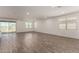 Spacious living area with wood-look floors, large windows, and ample natural light at 4034 W Nora Dr, San Tan Valley, AZ 85144
