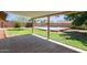 A covered patio overlooks the expansive backyard with a refreshing pool and mature landscaping at 4107 W Campo Bello Dr, Glendale, AZ 85308