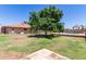 Expansive backyard with mature trees, lush lawn, pool, and space for entertaining at 4107 W Campo Bello Dr, Glendale, AZ 85308