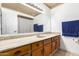 Bright bathroom featuring a large mirror, neutral-toned vanity, and updated fixtures at 4107 W Campo Bello Dr, Glendale, AZ 85308