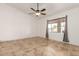 Bright bedroom featuring tile floors, ceiling fan, and a window with curtains that let in natural light at 4107 W Campo Bello Dr, Glendale, AZ 85308