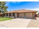 Well-kept home featuring a spacious driveway and manicured front yard at 4107 W Campo Bello Dr, Glendale, AZ 85308