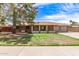 Charming single-story home with a well-maintained lawn and a welcoming facade at 4107 W Campo Bello Dr, Glendale, AZ 85308