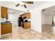 Efficient kitchen featuring oak cabinets, black appliances, and tile flooring at 4107 W Campo Bello Dr, Glendale, AZ 85308