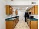 Efficient kitchen featuring oak cabinets, black appliances, and tile flooring at 4107 W Campo Bello Dr, Glendale, AZ 85308