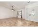 Bright living room featuring tile floors, ceiling fan, and a window with curtains that let in natural light at 4107 W Campo Bello Dr, Glendale, AZ 85308