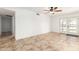 Bright living room featuring tile floors, ceiling fan, glass doors leading to the backyard, and access to the pool at 4107 W Campo Bello Dr, Glendale, AZ 85308