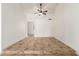 Bright living room featuring tile floors, ceiling fan, and a window with curtains that let in natural light at 4107 W Campo Bello Dr, Glendale, AZ 85308