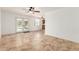 Bright living room featuring tile floors, ceiling fans, and glass doors leading to the backyard at 4107 W Campo Bello Dr, Glendale, AZ 85308
