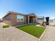 Outdoor living space featuring artificial turf, a fire pit, and a covered hot tub at 41800 W Sonoran Trl, Maricopa, AZ 85138